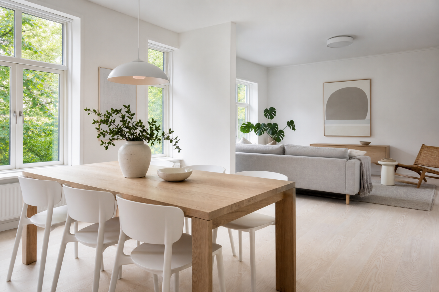 Bright Scandinavian dining and living space with pale timber and white walls