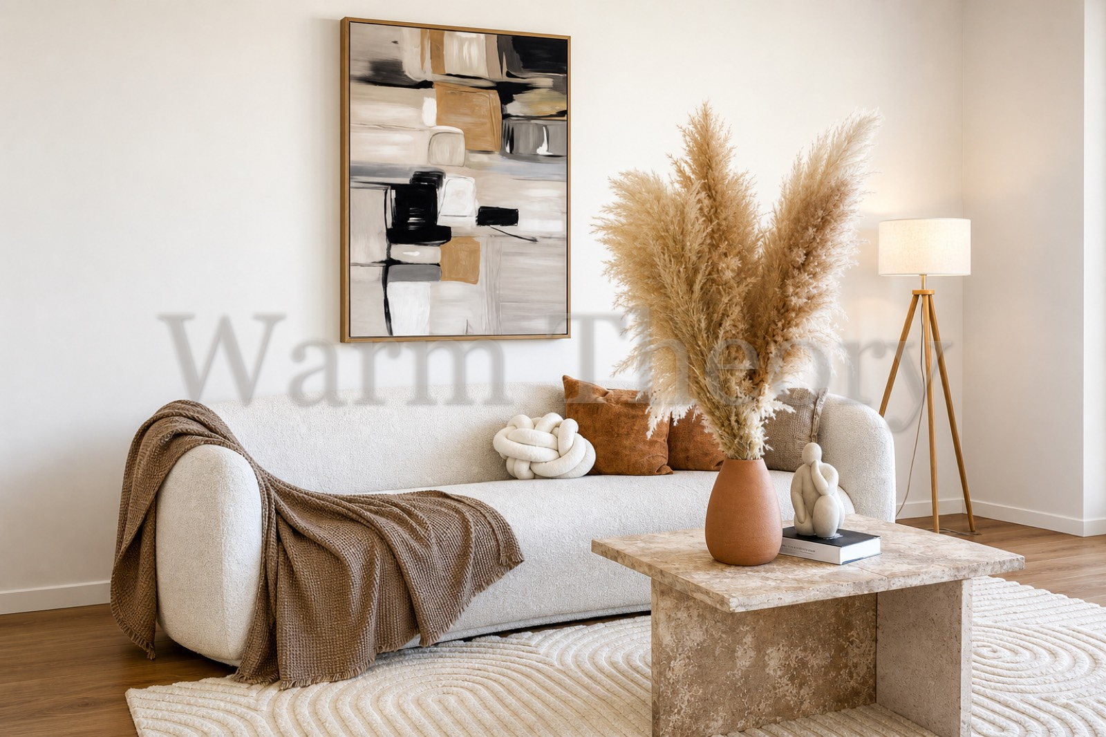 Staged living room with pampas grass, a travertine coffee table, and a cream boucle sofa